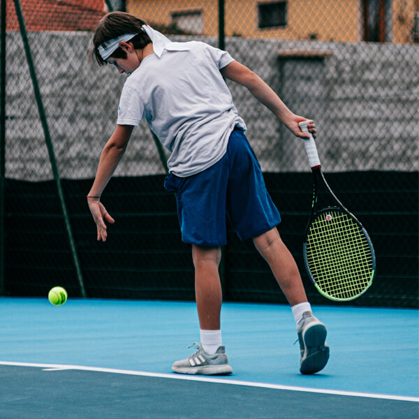 Disabled Person Playing Tennis with grip strips on badminton racket