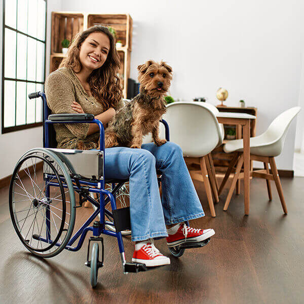 Disabled woman in wheelchair with her pet dog