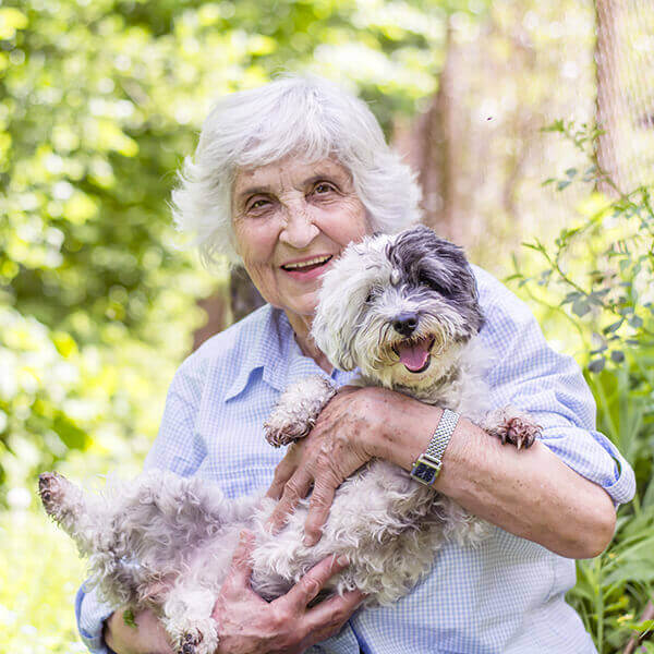 Elderly lady with her pet dog smiling