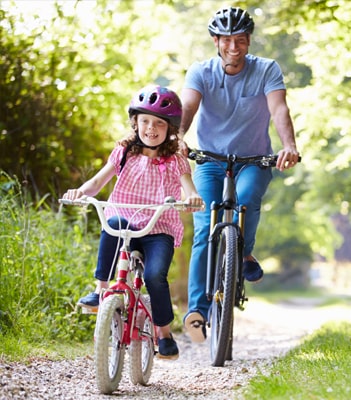 Family cycling in the sun