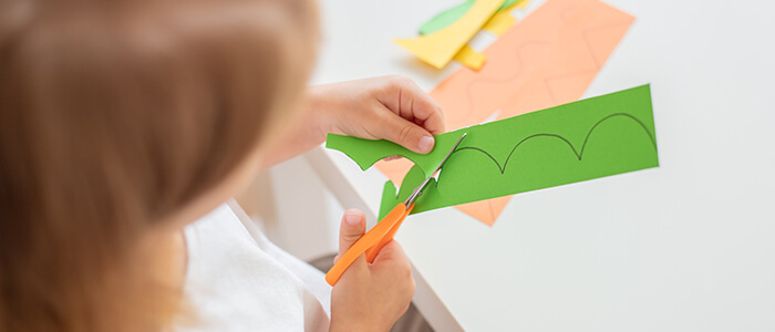 a-child-developing-fine-motor-skills-by-cutting-paper