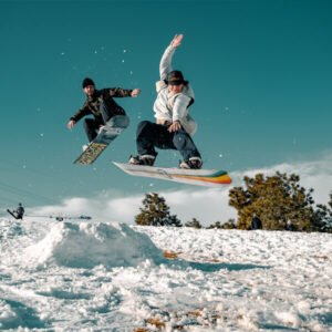 Two People Riding Snowboards
