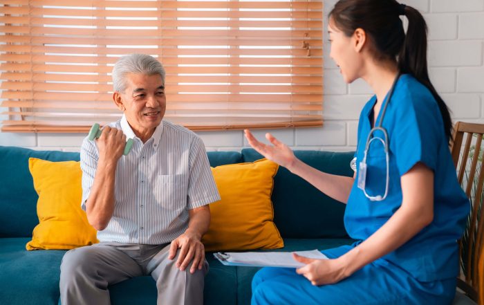 Elderly Man Improving Grip with Dumbells Through Physical Therapy