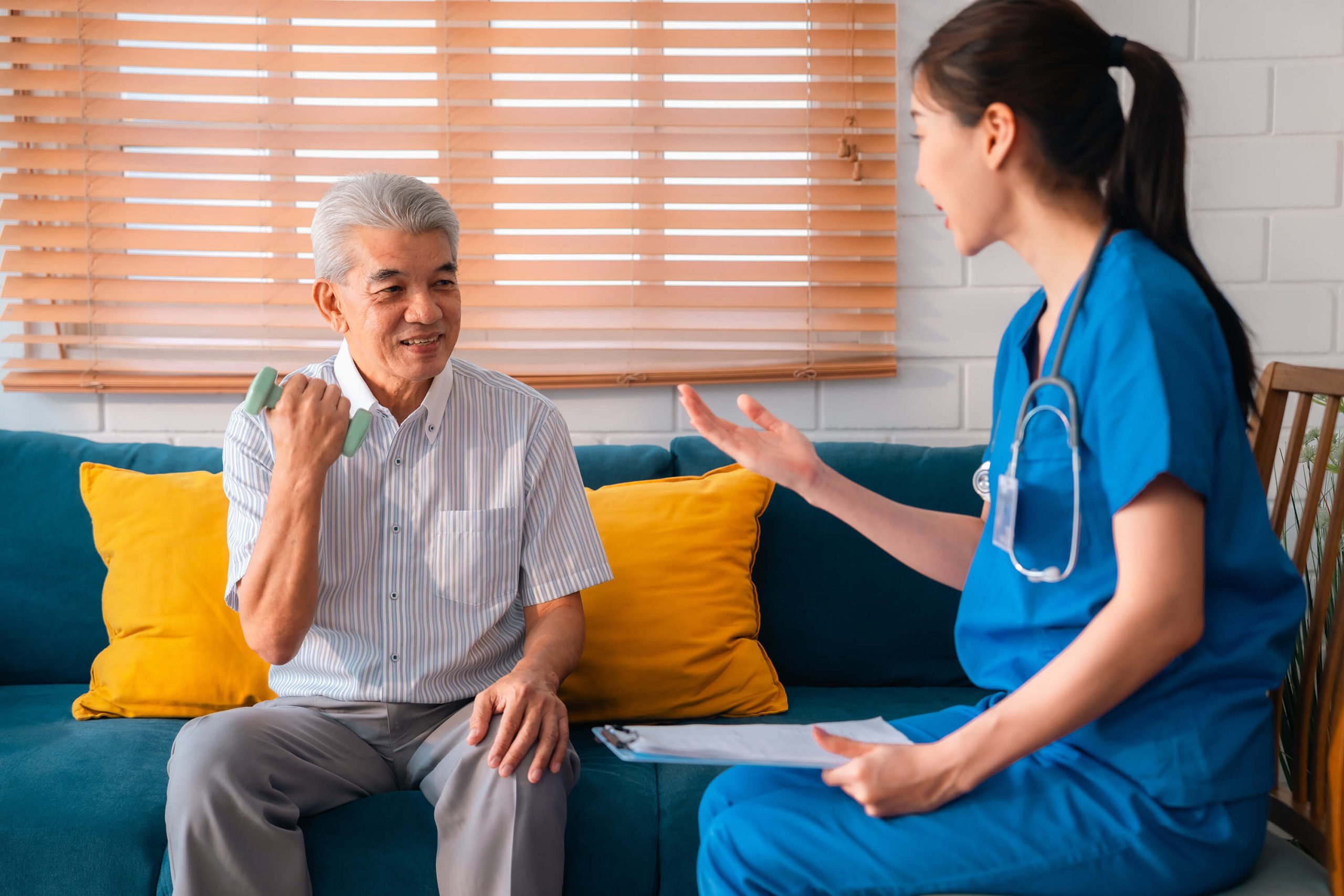 Elderly Man Improving Grip with Dumbells Through Physical Therapy