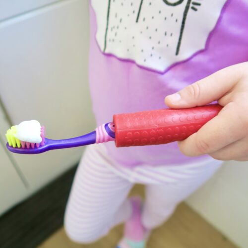 T-PCG-R-Red-Childrens-Cutlery-Grips-Girl-Holding-Toothbrush-1