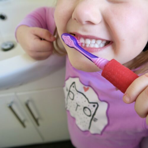 T-PCG-R-Red-Childrens-Cutlery-Grips-Girl-Holding-Toothbrush-2