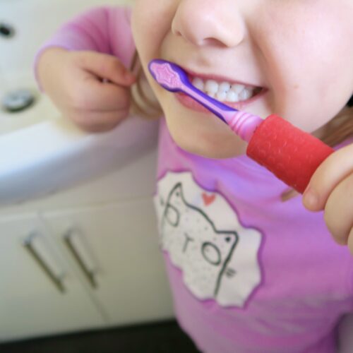 T-PCG-R-Red-Childrens-Cutlery-Grips-Girl-Holding-Toothbrush-4