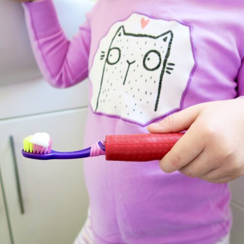 T-PCG-R-Red-Childrens-Cutlery-Grips-Girl-Holding-Toothbrush-3